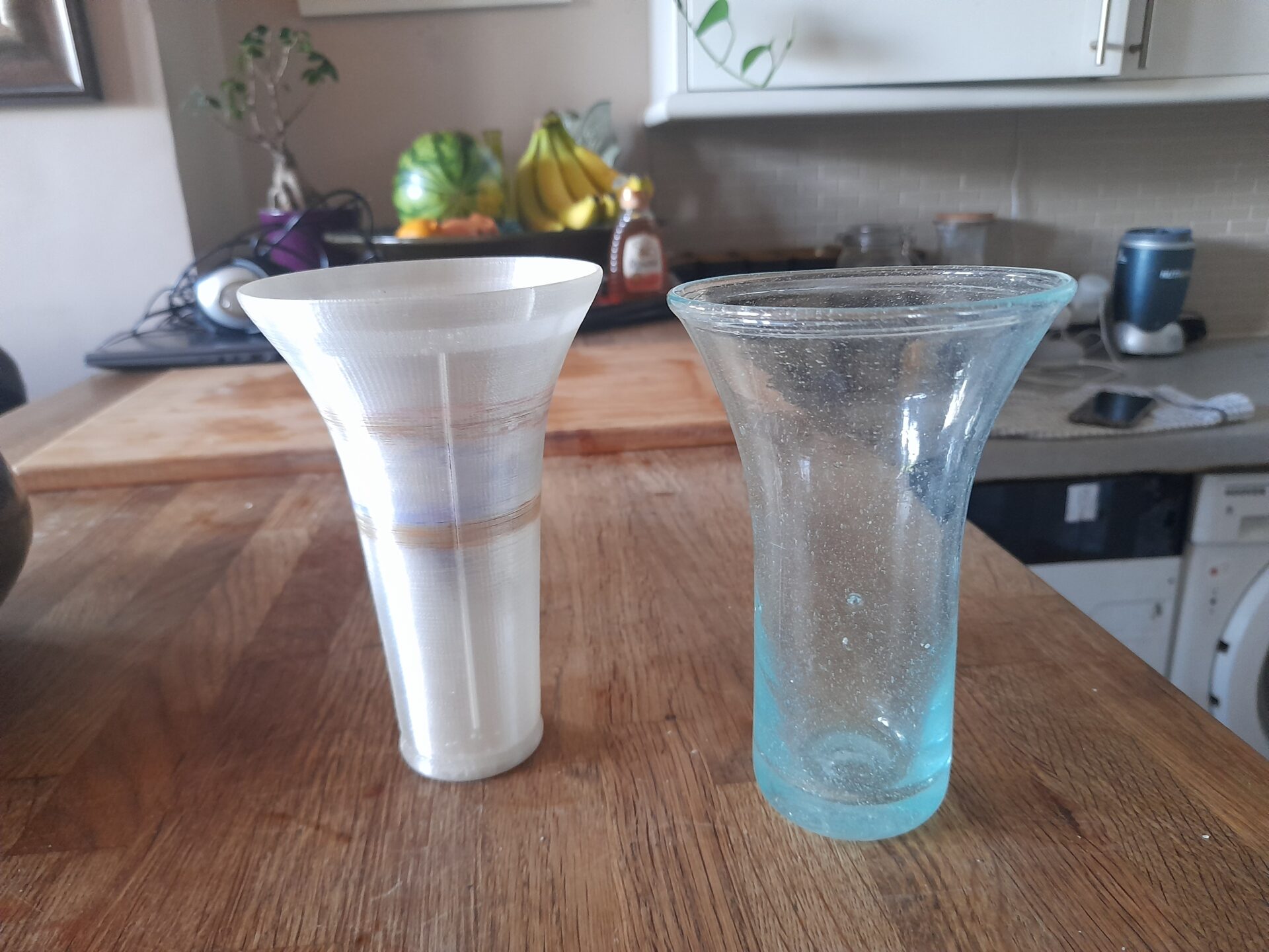 3D printed beaker prototype beside an authentic clear glass beaker from Cairo, Egypt.